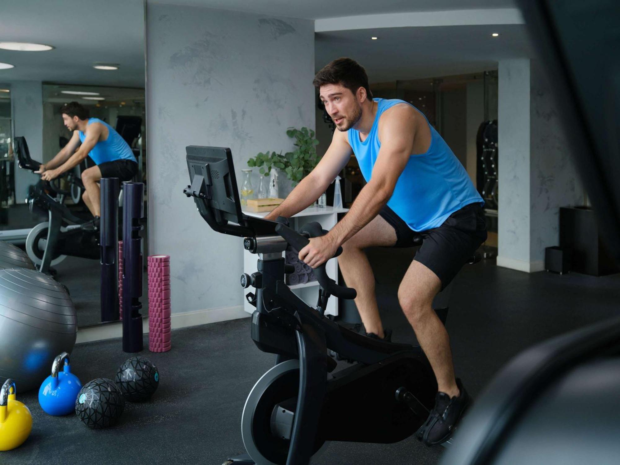 Pullman Jakarta Central Park Exterior foto A man on a stationary bicycle